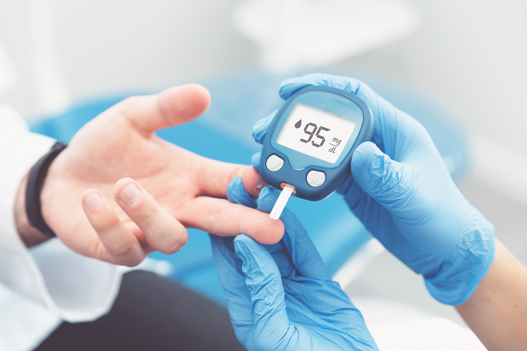 Doctor Checking Blood Sugar Level with Glucometer