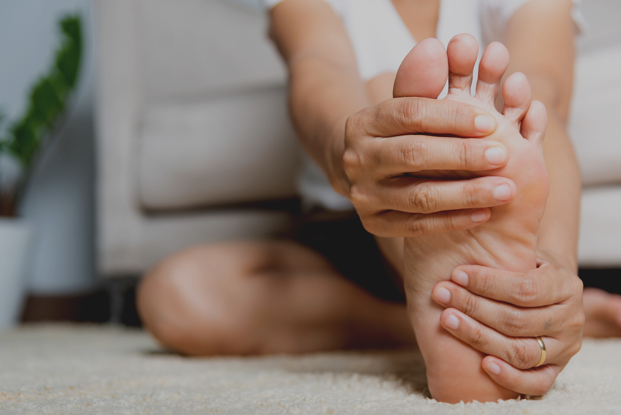 Asian Woman Feeling Pain in Her Foot at Home